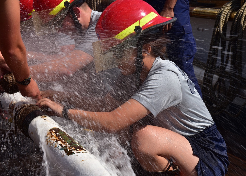 Swabs learn to handle the pressure during pipe patch training aboard Coast Guard Cutter Eagle