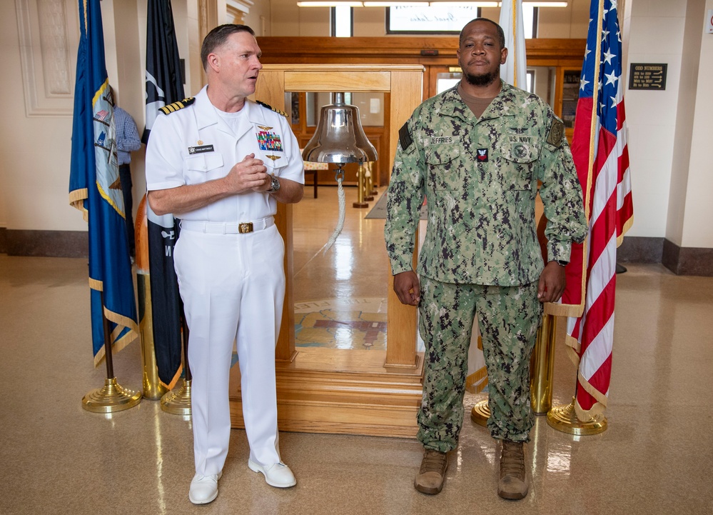 Capt. Craig Mattingly Awards Aviation Electricians Mate 1st Class Steven Jeffries Navy and Marine Corps. Commendation Medal