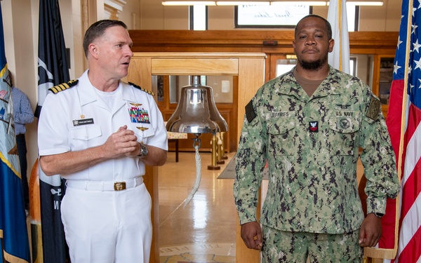 Capt. Craig Mattingly Awards Aviation Electricians Mate 1st Class Steven Jeffries Navy and Marine Corps. Commendation Medal