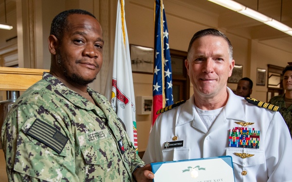 Capt. Craig Mattingly Awards Aviation Electricians Mate 1st Class Steven Jeffries Navy and Marine Corps. Commendation Medal