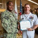 Capt. Craig Mattingly Awards Aviation Electricians Mate 1st Class Steven Jeffries Navy and Marine Corps. Commendation Medal