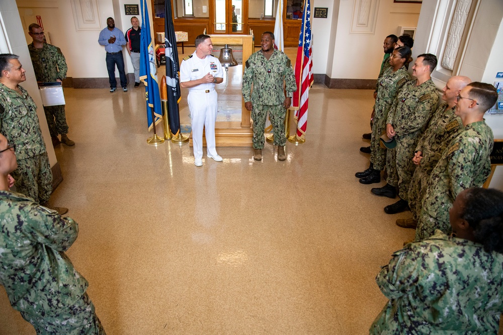 Capt. Craig Mattingly Awards Aviation Electricians Mate 1st Class Steven Jeffries Navy and Marine Corps. Commendation Medal