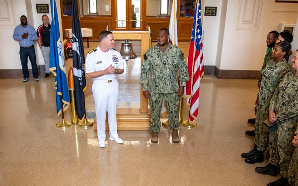 Capt. Craig Mattingly Awards Aviation Electricians Mate 1st Class Steven Jeffries Navy and Marine Corps. Commendation Medal