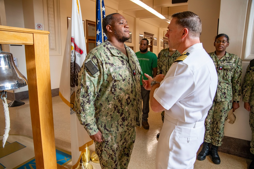 Capt. Craig Mattingly Awards Aviation Electricians Mate 1st Class Steven Jeffries Navy and Marine Corps. Commendation Medal