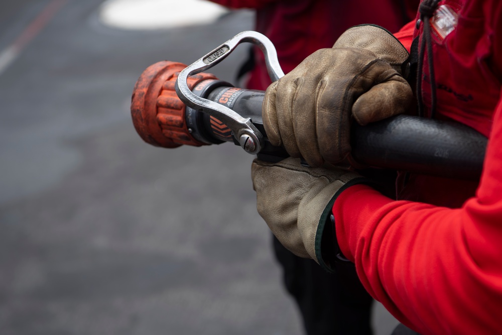 Sailor Aboard USS Carl Vinson (CVN 70) Participate in a Crash and Salvage Drill