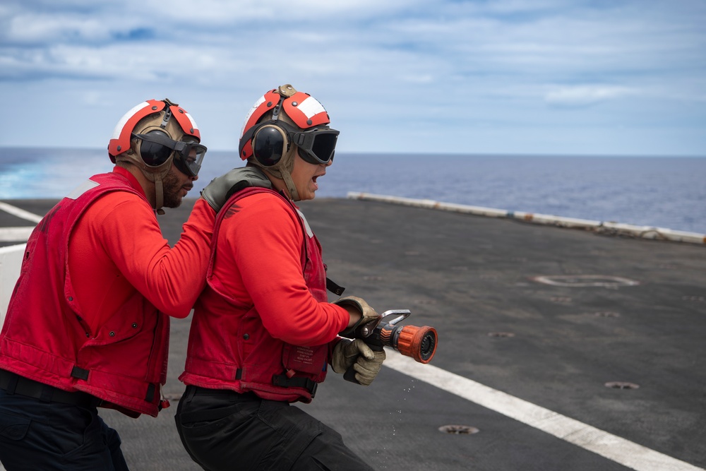 Sailor Aboard USS Carl Vinson (CVN 70) Participate in a Crash and Salvage Drill