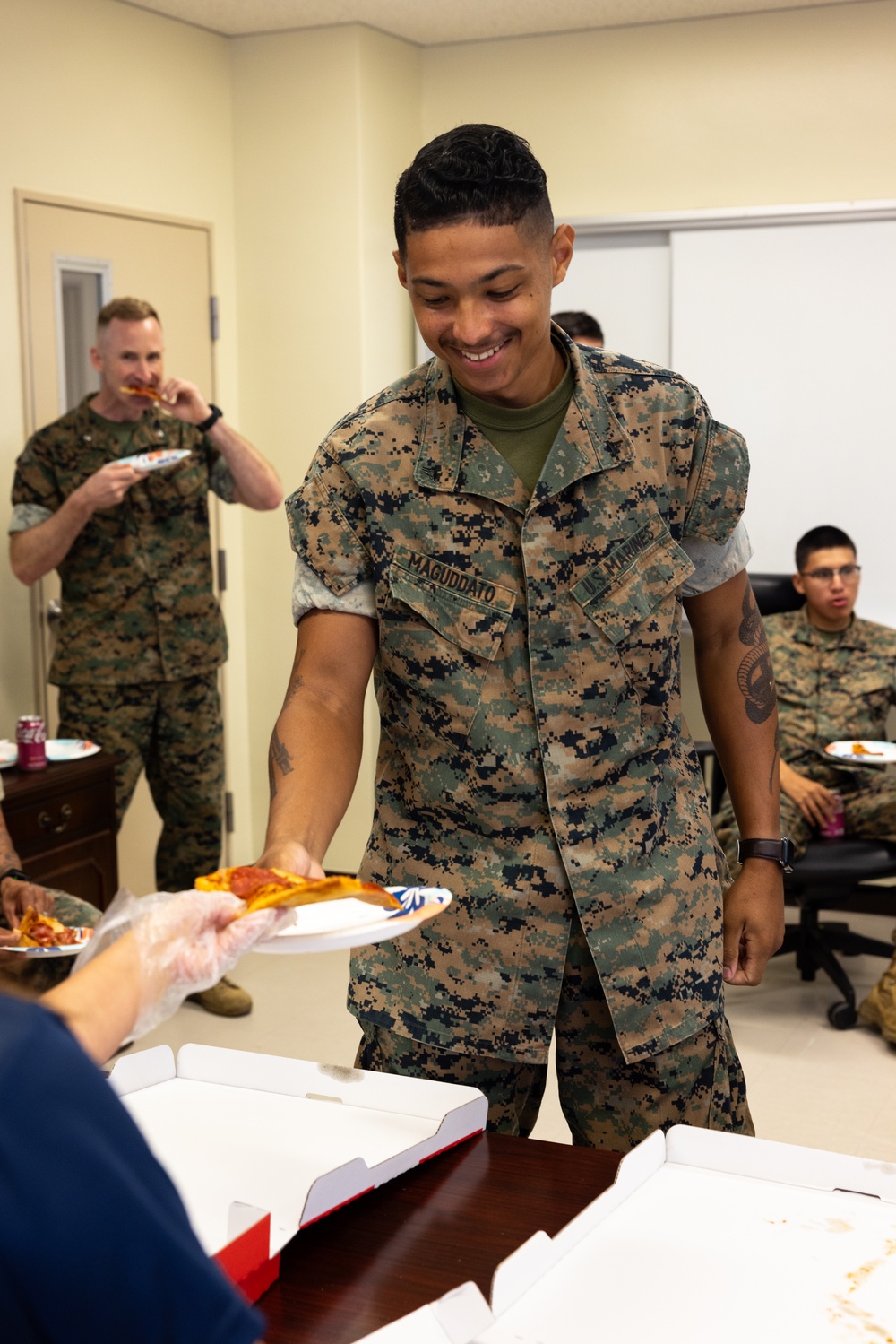 USO Foster provides pizza for Marines with CLR-3 for helping Camp Foster recover from Typhoon Khanun
