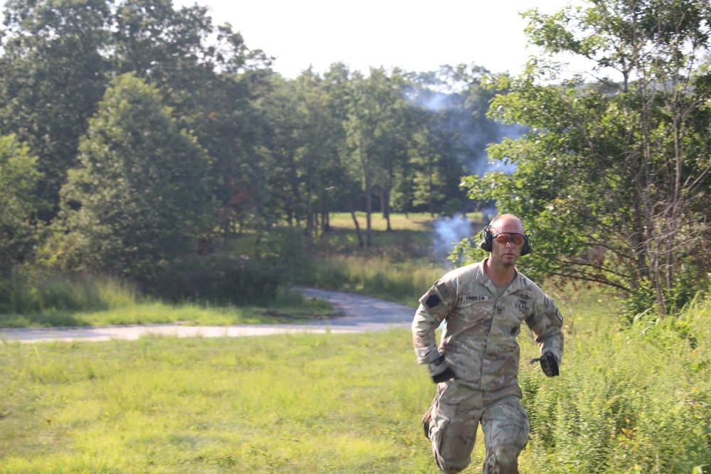Officer candidate school instructor marks landing zone with green smoke