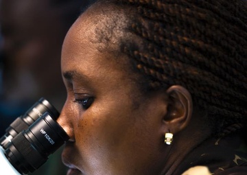 Lt. Col. Julianna Munyao, Kenya Defence Forces, identifies different mosquito species through a microscope at the Africa Malaria Task Force (AMTF) conference, July 18, 2023.