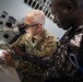 U.S. Army Col. Tom Eccles, United States Africa Command surgeon, identifies different mosquito species through a microscope with Deputy Superintendent of Police Emmanuel Baba Asabila, Ghana Police.