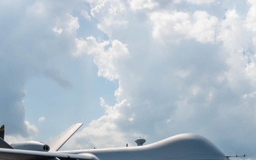Wing refuels Unmanned Aerial Vehicle with HC-130J aircraft