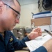 USS Ronald Reagan (CVN 76) Sailors work in the post office