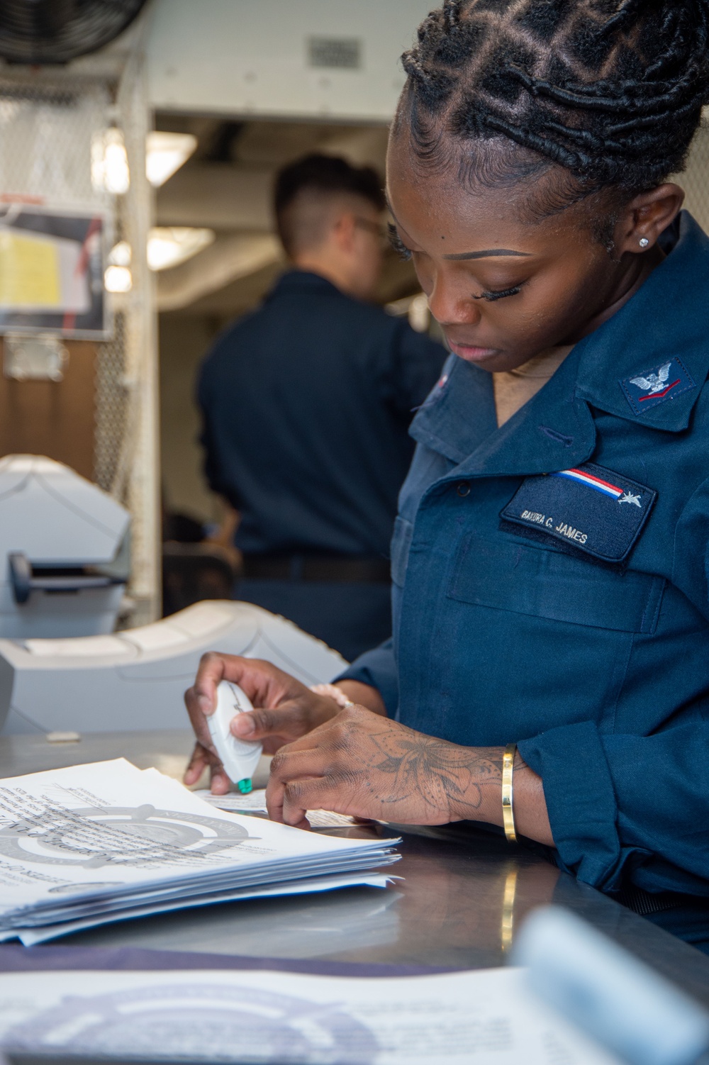 USS Ronald Reagan (CVN 76) Sailors work in the post office