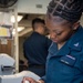 USS Ronald Reagan (CVN 76) Sailors work in the post office