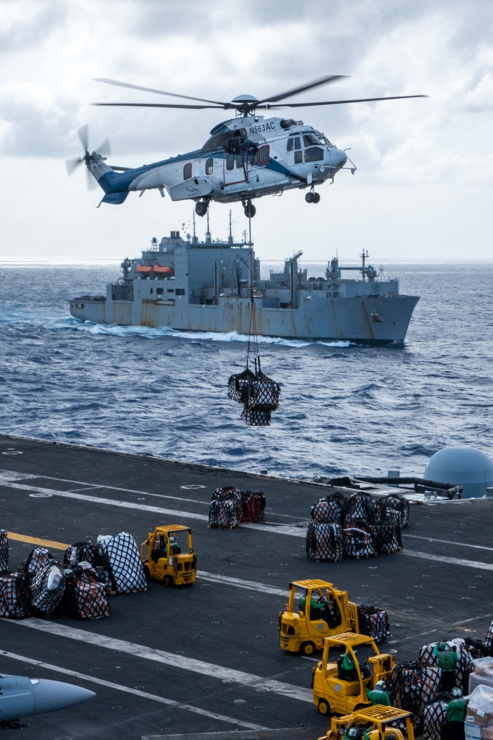 USS Ronald Reagan (CVN 76) conducts replenishment-at-sea with USNS Yukon (T-AO 202) and USNS Carl Brashear (T-AKE 7)