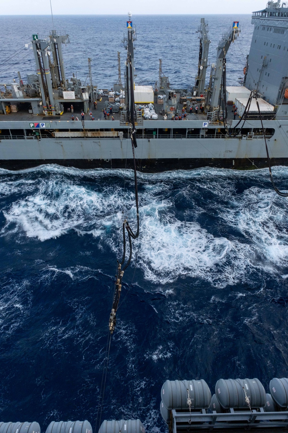 USS Ronald Reagan (CVN 76) conducts replenishment-at-sea with USNS Yukon (T-AO 202) and USNS Carl Brashear (T-AKE 7)