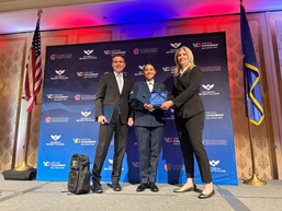 Senior Airman Lea Williams, 232nd Combat Training Squadron, Nevada Air National Guard, accepts MAC Night Out Airman of the Year award.