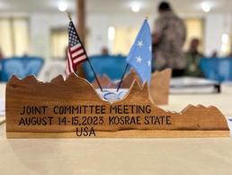A plaque at the 2023 Joint Committee Meeting in Kosrae