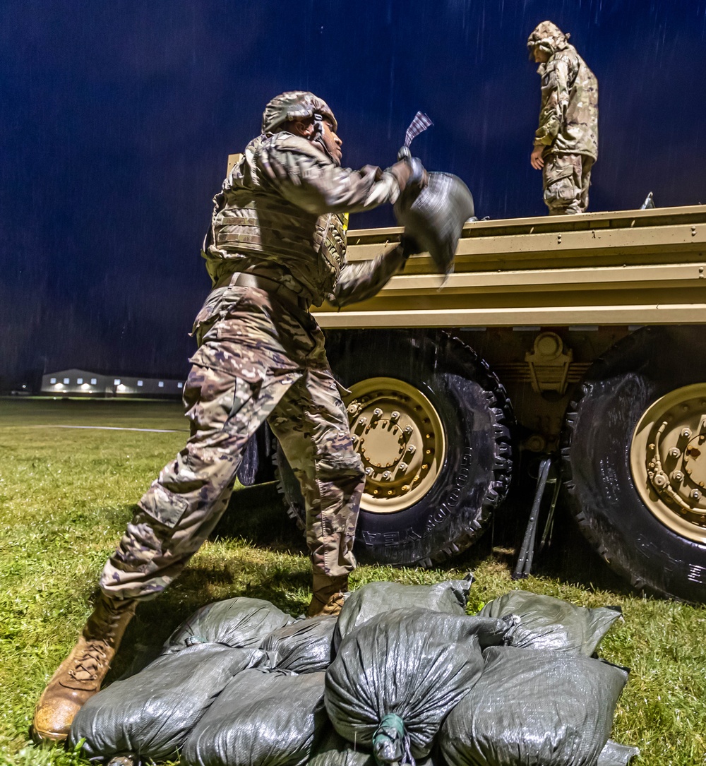 Sgt.1st Class Charles Blackwell throws a sand bag