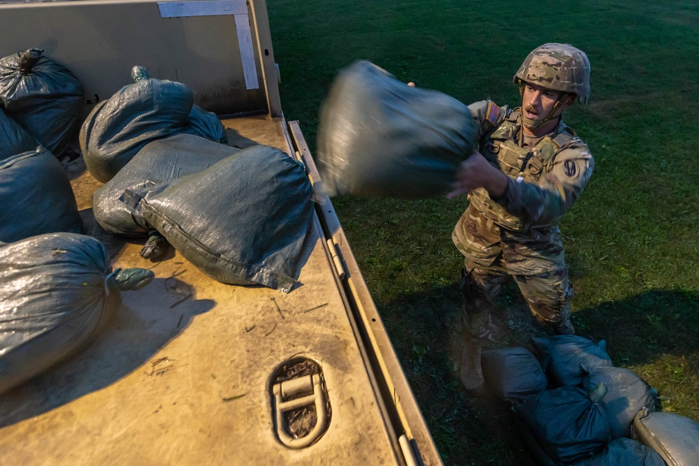 Staff Sgt. James Lavoie throws a sand bag