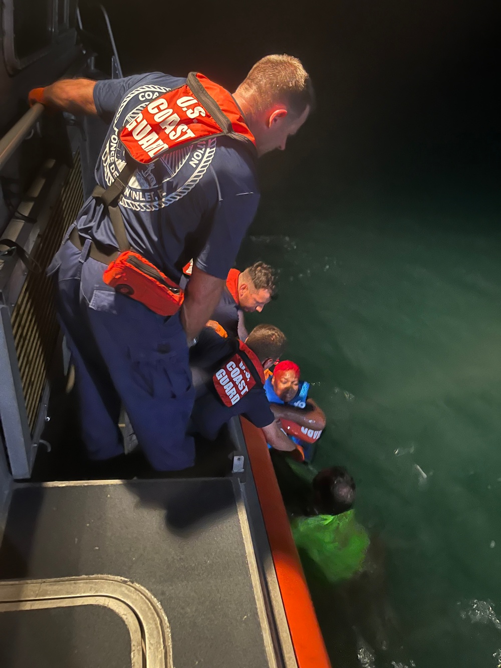 A Coast Guard Station Ponce de Leon Inlet boat crew and a swimmer from Volusia County Beach Safety rescue three people who were stranded on the Ponce de Leon Inlet jetties in Ponce Inlet, Florida, Aug. 13, 2023. The rescue individuals were safely transported to awaiting EMS at Station Ponce de Leon Inlet with no reported medical concerns. (U.S. Coast Guard photo, courtesy Station Ponce de Leon Inlet)