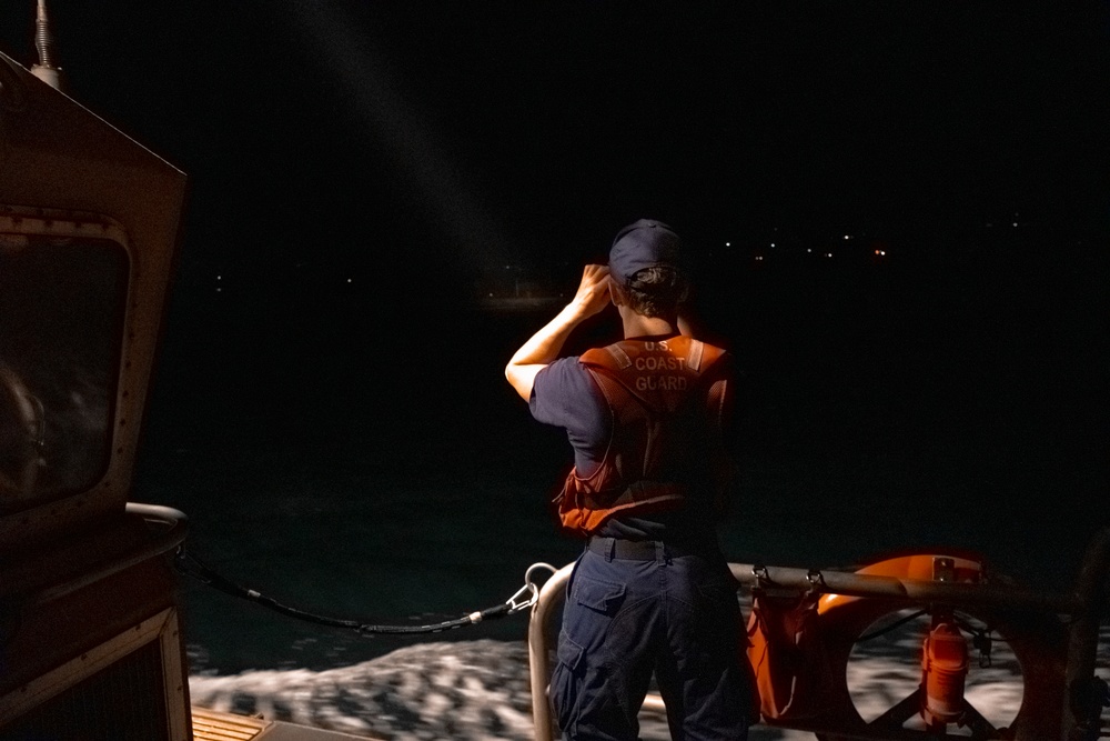 U.S. Coast Guard member conducting shoreline searches