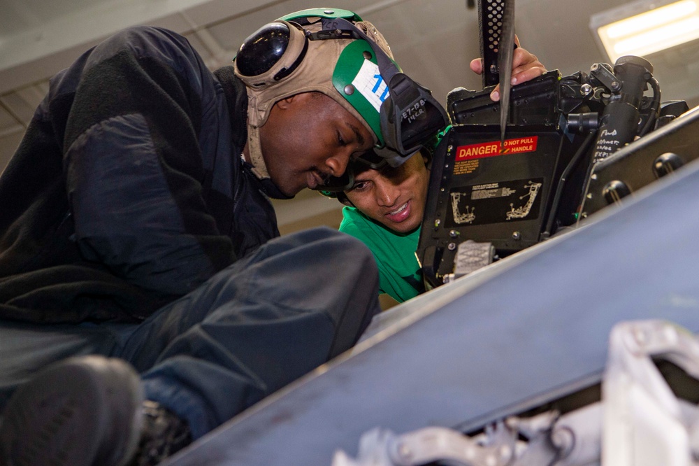 Sailors install seats on an F/A-18F Super Hornet Aboard USS Carl Vinson (CVN 70)