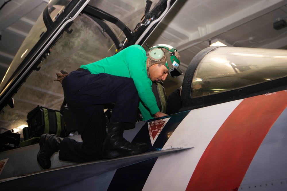 Sailor installs seats on an F/A-18F Super Hornet Aboard USS Carl Vinson (CVN 70)