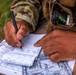 Sgt. 1st Class Karlee Walker writes down his points