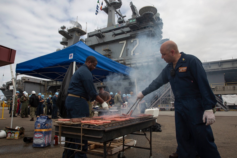 Sailors participate in a fundraising BBQ event