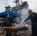 Sailors participate in a fundraising BBQ event