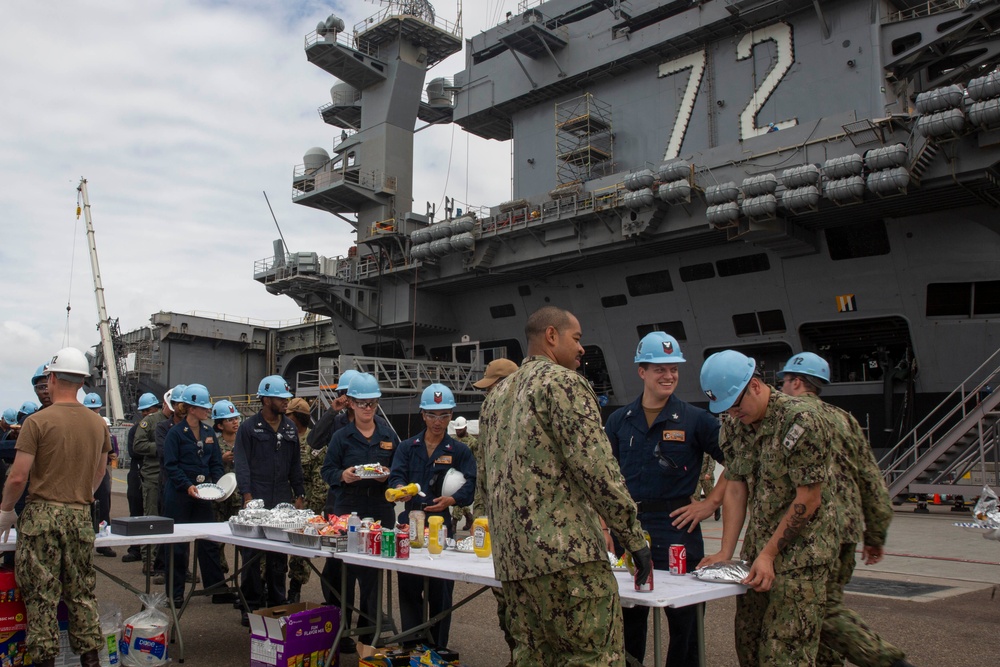 Sailors participate in a fundraising BBQ event