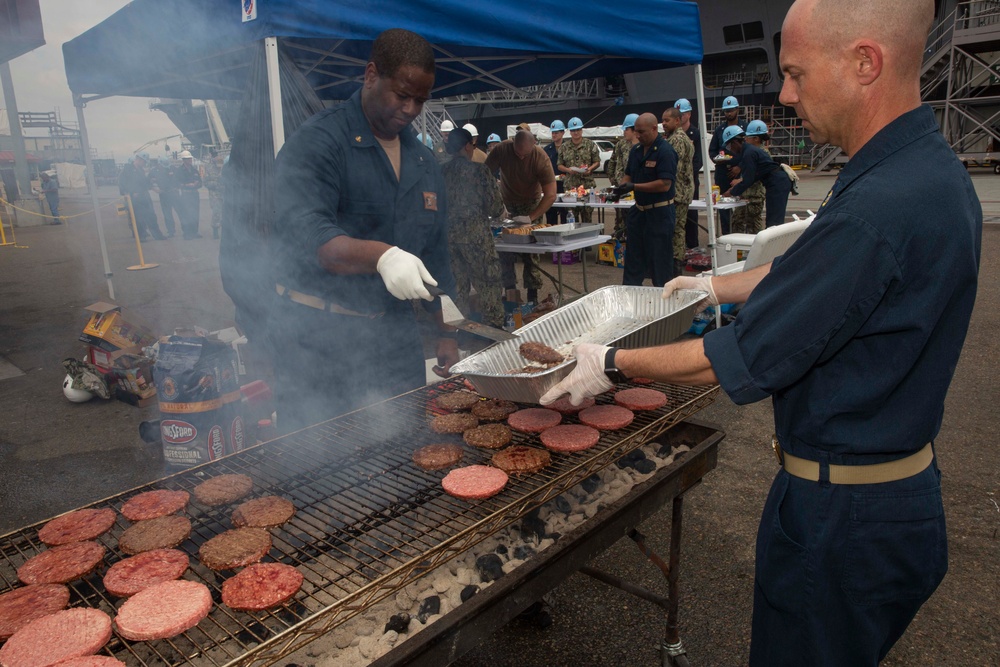 Sailors participate in a fundraising BBQ event