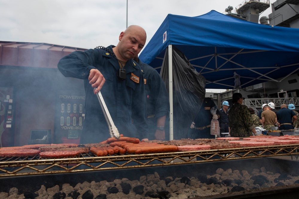 Sailors participate in a fundraising BBQ event