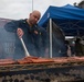 Sailors participate in a fundraising BBQ event