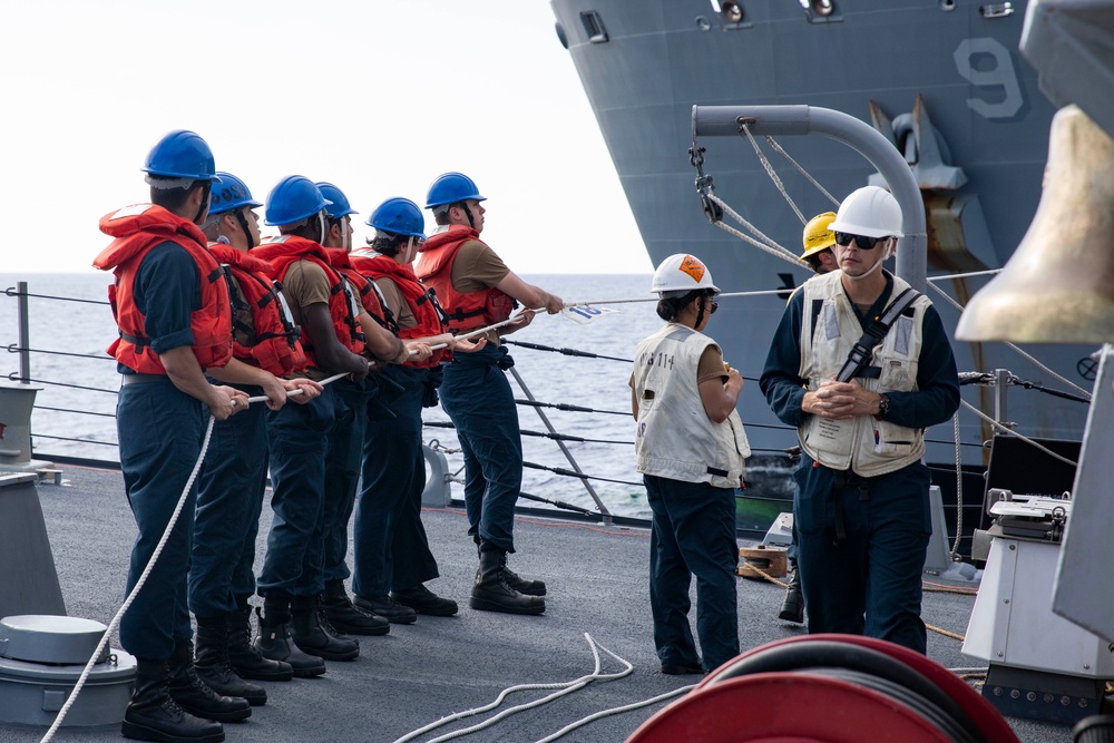 USS Ralph Johnson (DDG 114) conducts a replenishment-at-sea with the USNS Matthew Perry (T-AKE-9).