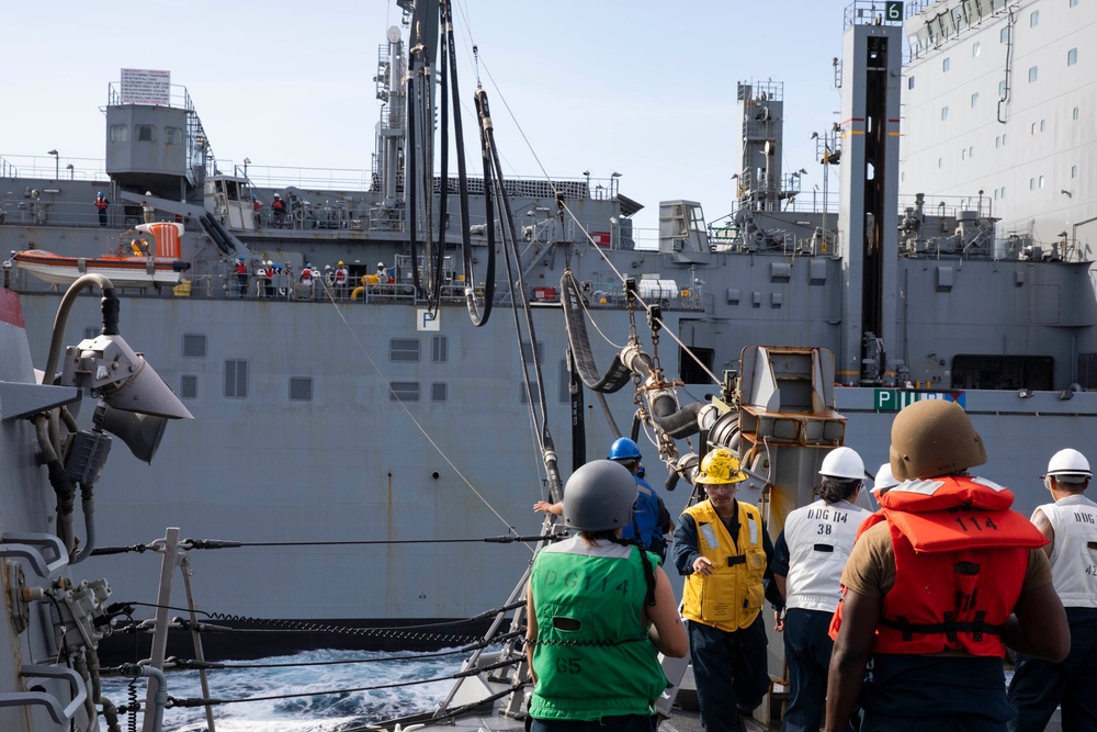 USS Ralph Johnson (DDG 114) conducts a replenishment-at-sea with the USNS Matthew Perry (T-AKE-9).