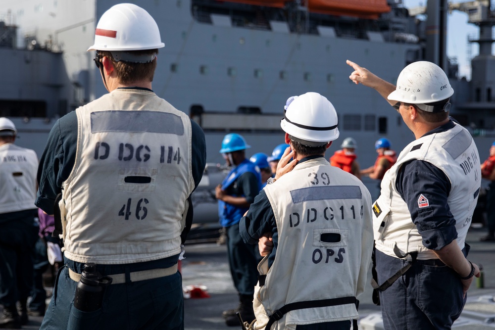 USS Ralph Johnson (DDG 114) conducts a replenishment-at-sea with the USNS Matthew Perry (T-AKE-9).