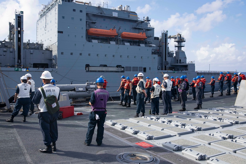 USS Ralph Johnson (DDG 114) conducts a replenishment-at-sea with the USNS Matthew Perry (T-AKE-9).