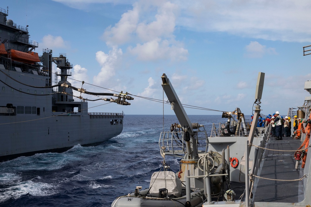 USS Ralph Johnson (DDG 114) conducts a replenishment-at-sea with the USNS Matthew Perry (T-AKE-9).