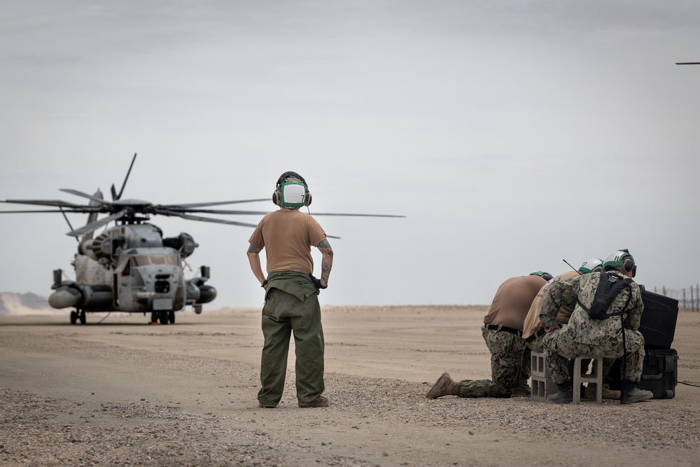 Marines and Sailors conduct ground refuel on MQ-8C Fire Scout.