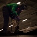 USS Carl Vinson (CVN 70) Sailor Performs Maintenance on a Jet