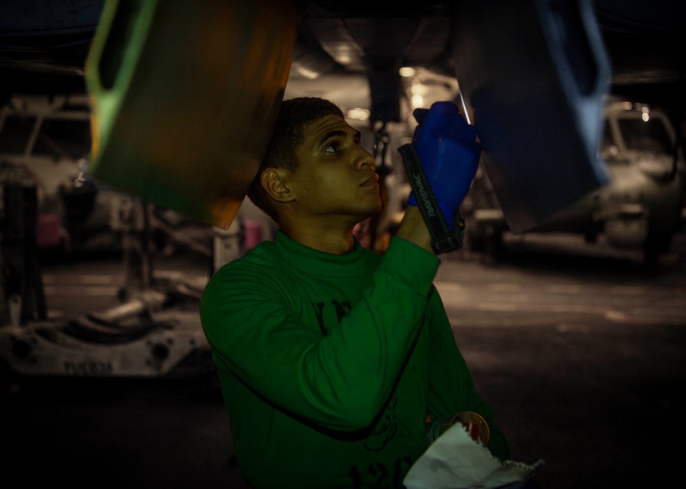 USS Carl Vinson (CVN 70) Sailor Performs Inspection on a Jet