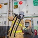 Sailors Aboard George Washington Don Firefighting Equipment