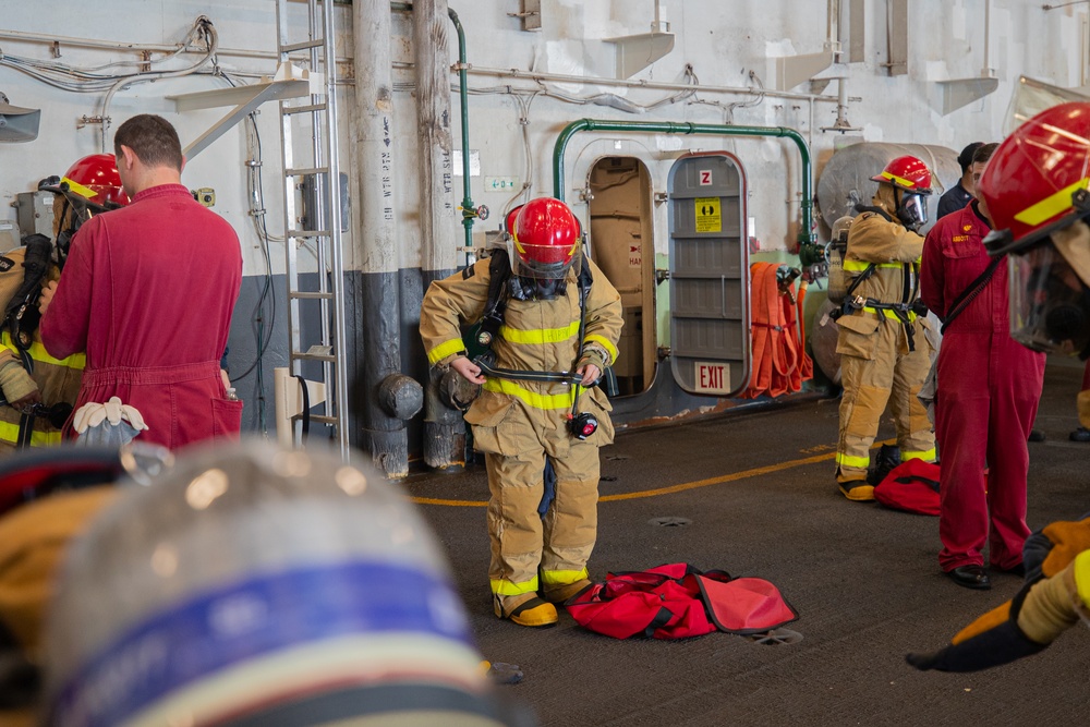 Sailors Aboard CVN 73 Don Firefighting Equipment