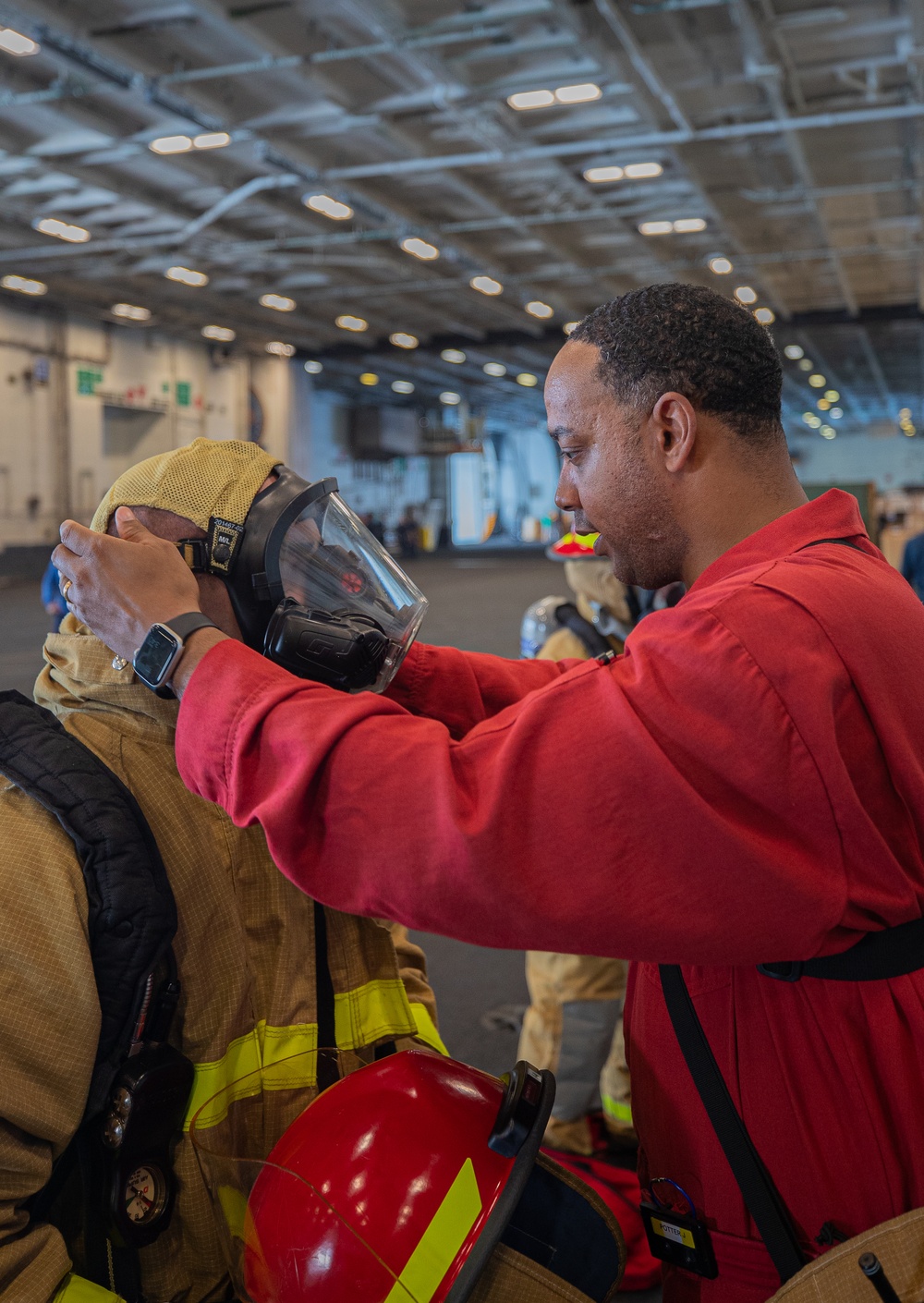 Sailors Aboard George Washington Don Firefighting Equipment