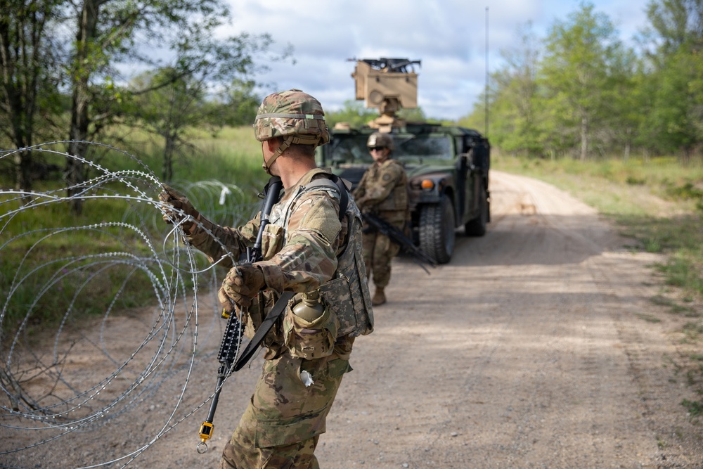 Soldiers with the 1431st Engineer Company set up a concertina wire obstacle during Exercise Northern Strike 2023