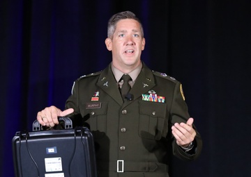 Lt Col Murphy explains portable hearing test equipment at DHITS 2023