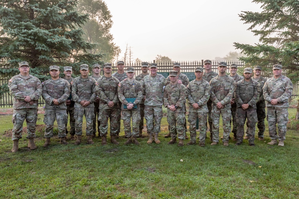 Maj. Gen. Gene LeBoeuf stands with the 16 Expert Soldier Badge recipients and the two board presidents