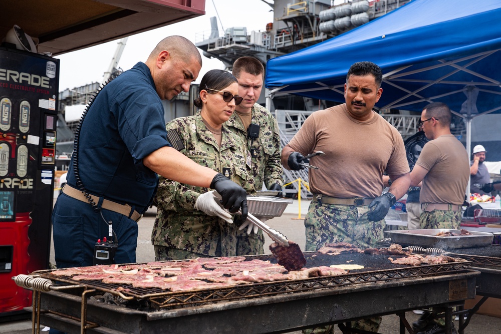 Abraham Lincoln Sailors participate in a fundraising BBQ event